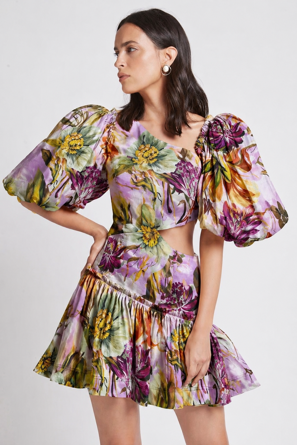 Woman wearing a floral linen plum dress with puffed sleeves.
