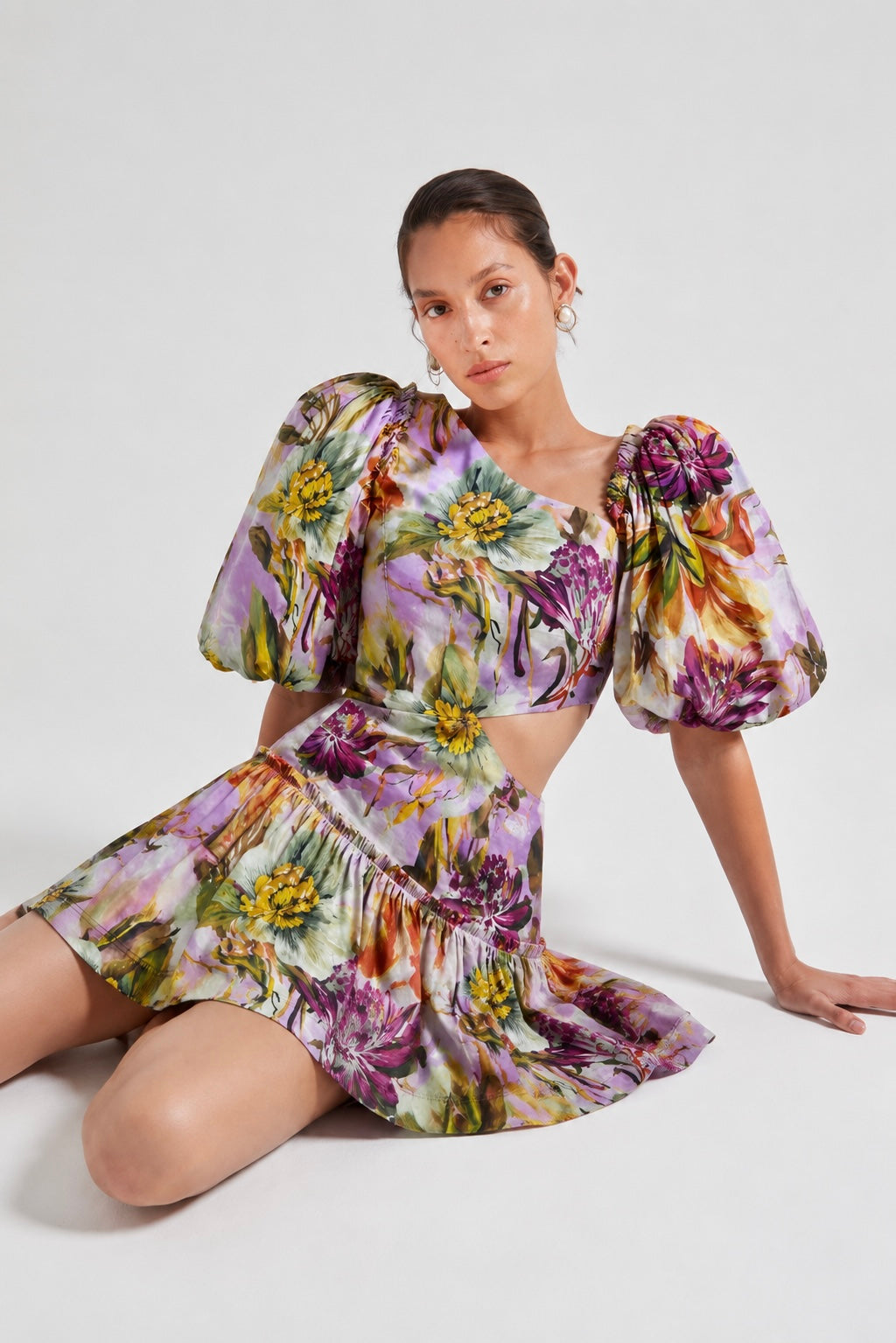 Woman wearing a floral linen plum dress with puffed sleeves