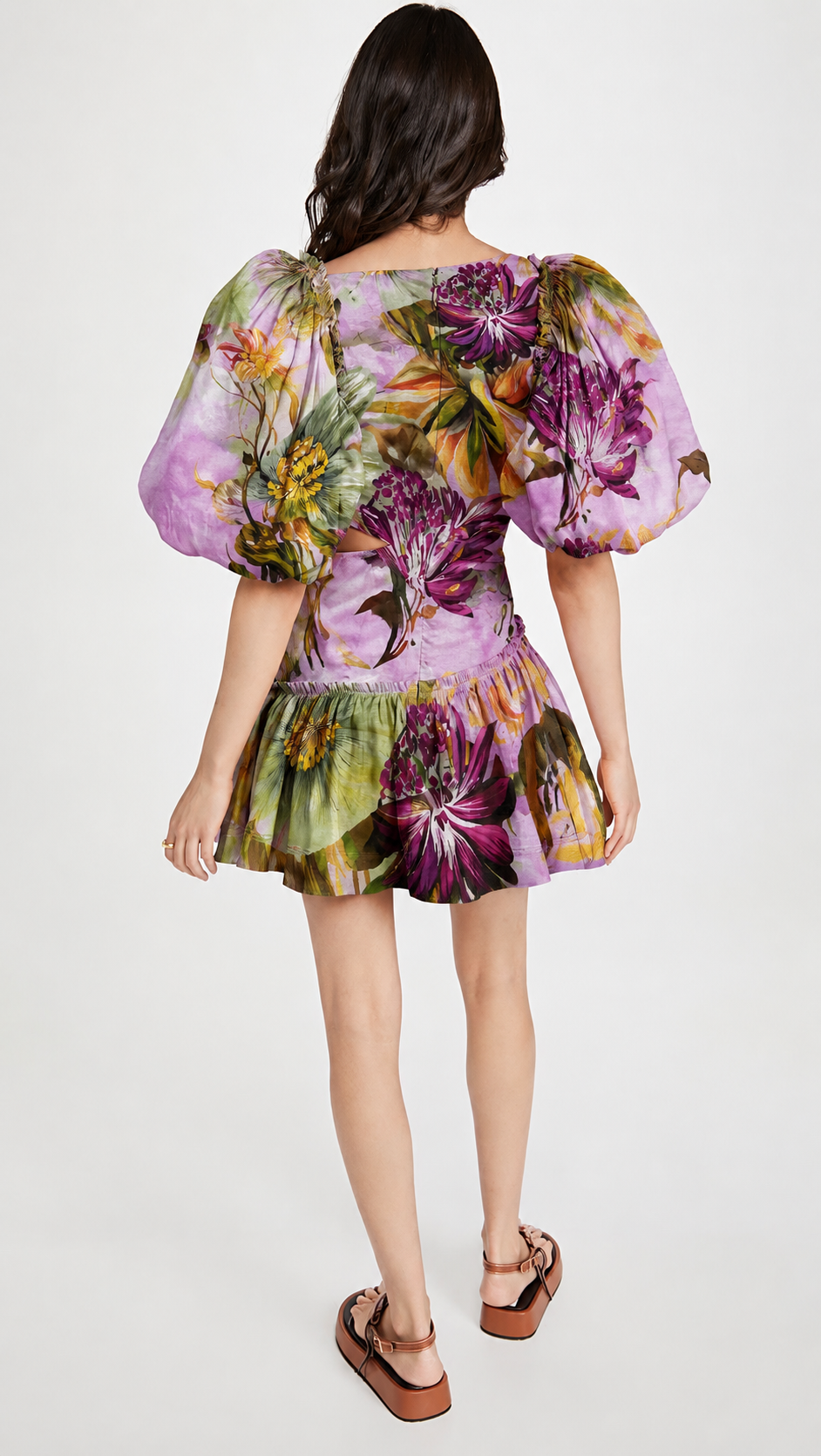 Woman wearing a floral linen plum dress with puffed sleeves.