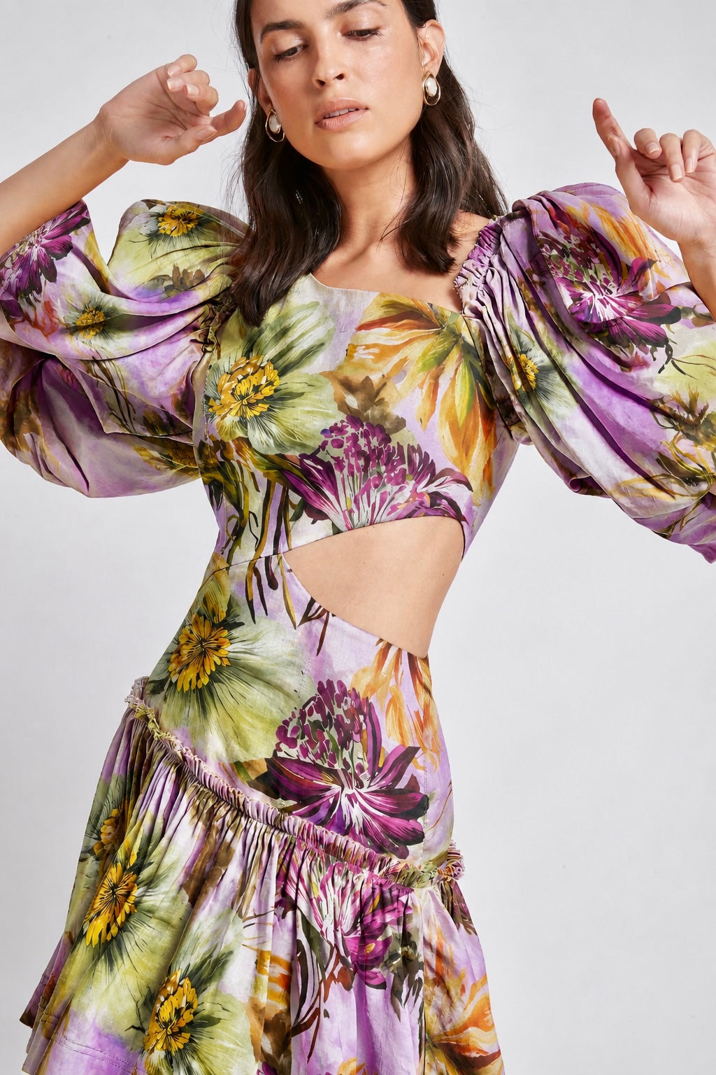 Woman wearing a floral linen plum dress with puffed sleeves