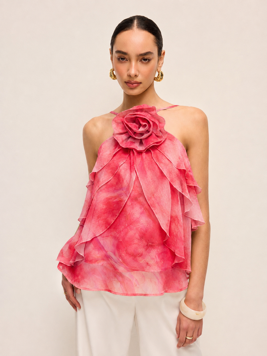 Woman wearing a pink floral rosy posy ruffle top