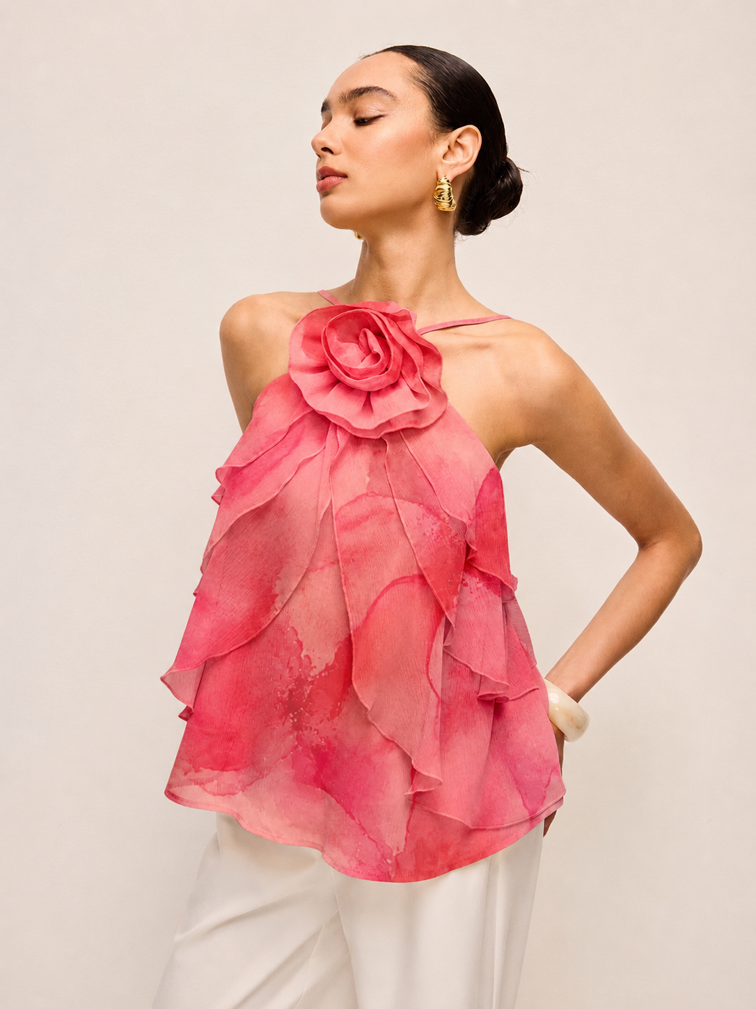 Woman wearing a pink floral rosy posy ruffle top