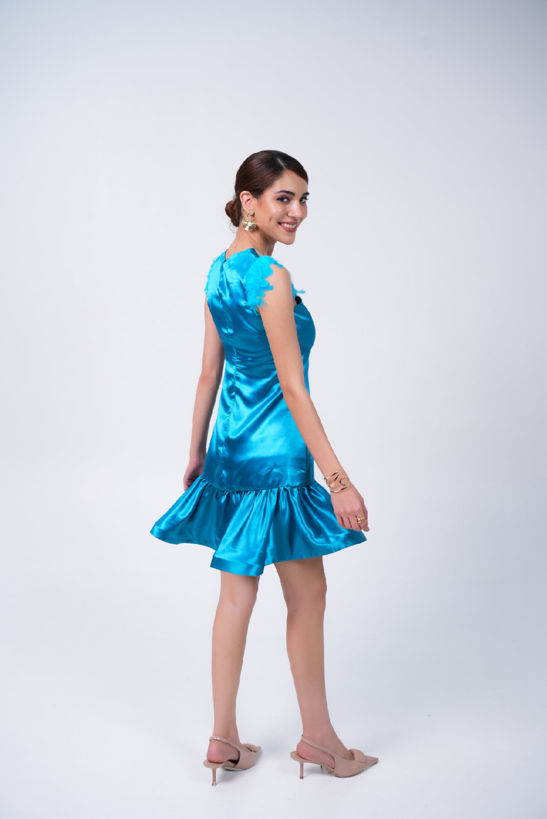 Woman wearing a blue mini dress on a white background